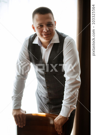 portrait of the groom of a man in the morning before the wedding 103325564