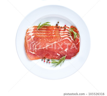 Spanish jamon cut, parma ham cutting with rosemary and spice in a plate isolated on white background. Spanish jamon cut, parma ham cutting with rosemary and spice in a plate isolated on white background. 103326316