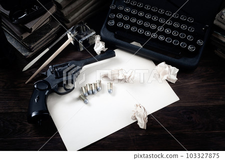 Antique typewriter and revolver gun with ammunitions, books, blank paper, old ink pen Antique typewriter and revolver gun with ammunitions, books, blank paper, old ink pen 103327875