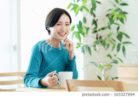 在客廳喝熱飲放鬆的女人 103327994