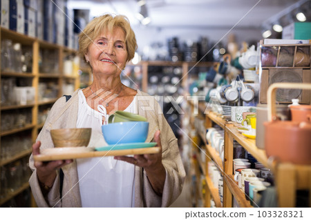 Woman choosing goods for kitchen at store 103328321