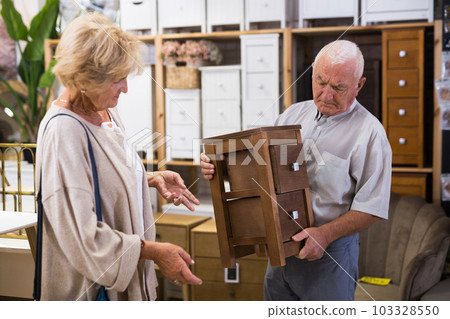 Couple buying wooden chest in a store 103328550