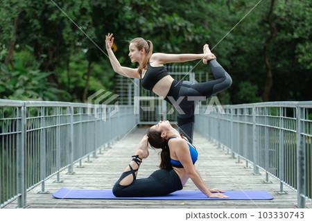 Beautiful female sport wear exercise arm stretching yoga in garden. sport for health. 103330743