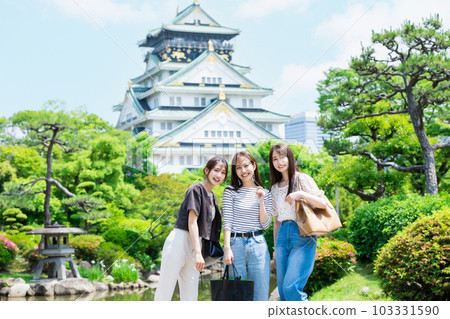 Women's trip A woman standing in front of the castle tower of Osaka Castle 103331590