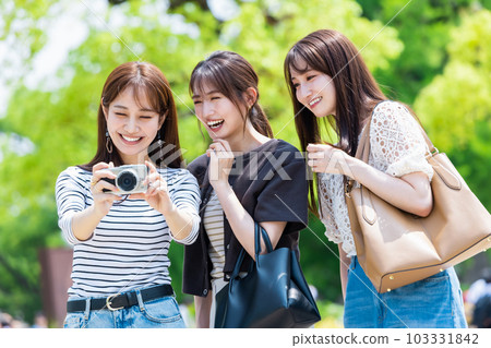Girls' trip A young woman sightseeing Osaka Castle with a camera 103331842