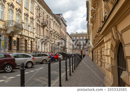 [Poland] Scenery with sidewalks and cars parked on the shoulder of a deserted alley in Krakow Old Town 103332085