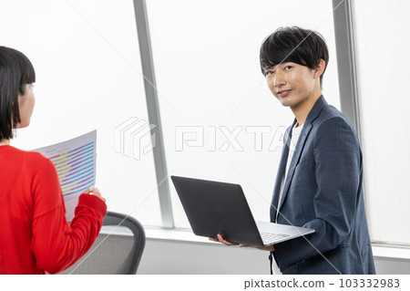 Young businessman having a meeting with a laptop 103332983