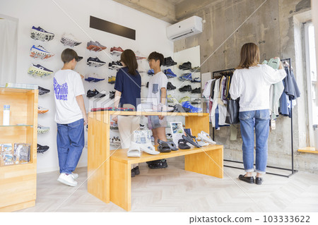 Young men and women shopping in a shoe shop Young men and women shopping in a shoe shop 103333622