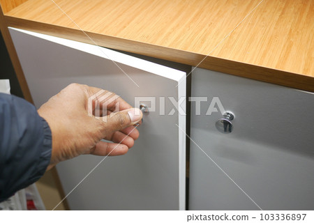 top view of men hand open a a drawer top view of men hand open a a drawer 103336897