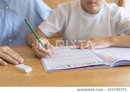 child doing homework with parent 103340371