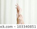 A woman doing hand care 103340851