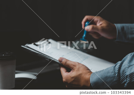 Signing approval record documents stamp confirmation occupation signature. businessman hand stamping finance paper work concept. 103343394