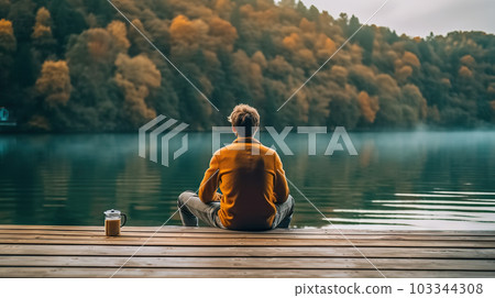 Lakeside Retreat: Young Man Embracing Freedom and Relaxation on the Pier with a Cup of Coffee. created with Generative AI Lakeside Retreat: Young Man Embracing Freedom and Relaxation on the Pier with a Cup of Coffee. created with Generative AI 103344308