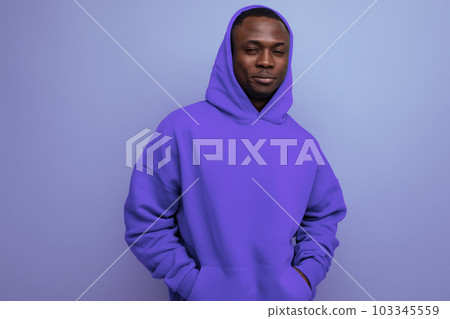 close-up portrait of a cute ethnic 25 year old african man in a stylish hoodie with a hood on a 103345559