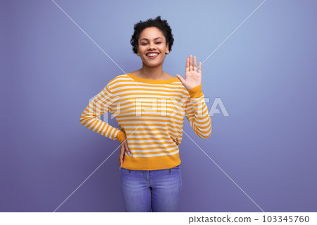 attractive latin young woman with afro hair in a yellow striped blouse 103345760