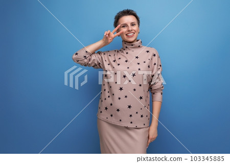smiling well-groomed young career woman with gray streaked hair dressed in a skirt and blouse 103345885