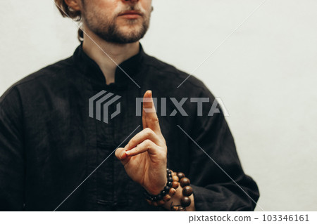 Hand with rosary shows the mudra of life. Qigong. Yoga. Close up. Hands folded in prayer. Hands together. Prayer, gratitude 103346161