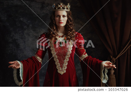 medieval queen in red dress with crown 103347026