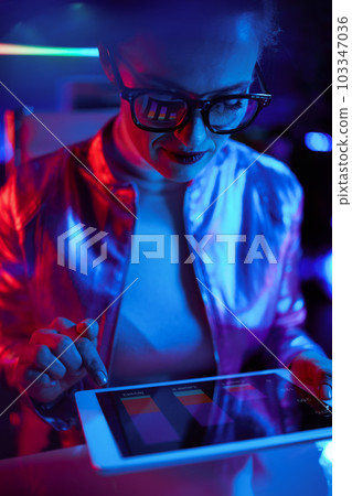 trendy female in glasses with tablet PC 103347036