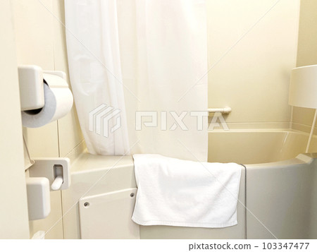 Towels and shower curtains hanging over a hotel unit bath Towels and shower curtains hanging over a hotel unit bath 103347477