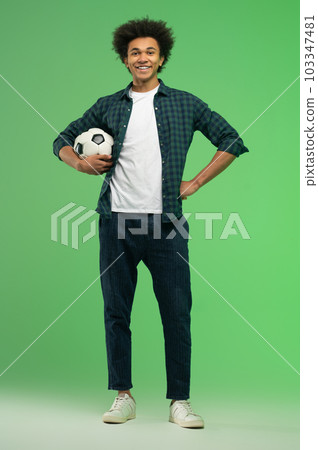 Young dark-skinned guy with a ball looking excited 103347481