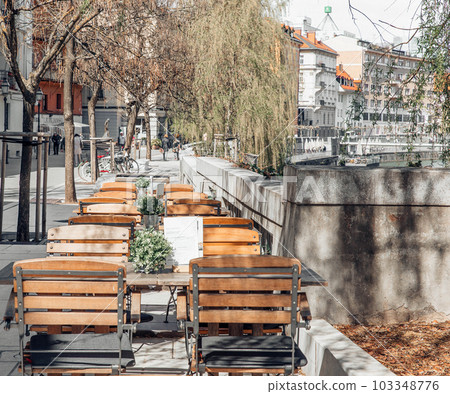 Center of the city, spring time, chairs near the cafe 103348776