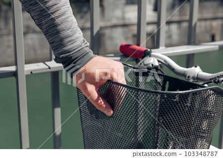 Hand of a hipster man in a big city in the street with a bicycle, a life style concept 103348787