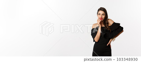 Fashion and beauty. Glamour woman in black dress thinking, having an idea, standing over white background Fashion and beauty. Glamour woman in black dress thinking, having an idea, standing over white background 103348930