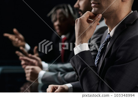 Close-up profile of a pensive manager, holding his hand on his chin 103348994