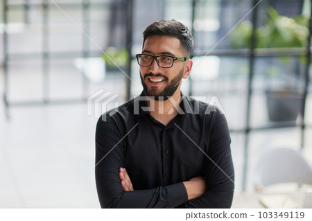 Portrait of smiling young businessman in office Portrait of smiling young businessman in office 103349119
