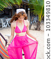 young girl sitting on the beach. by sea. tropical beach, summer style. 103349810