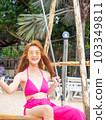 young girl sitting on the beach. by sea. tropical beach, summer style. 103349811