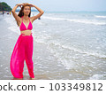 young girl sitting on the beach. by sea. tropical beach. summer style. 103349812