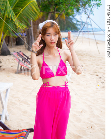 young girl sitting on the beach. by sea. tropical beach. summer style. 103349813