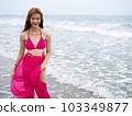 young girl sitting on the beach. by sea. tropical beach. summer style. 103349877