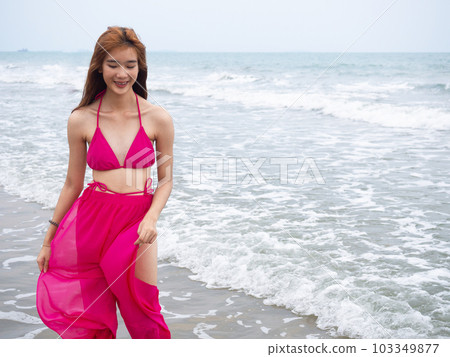 young girl sitting on the beach. by sea. tropical beach. summer style. 103349877