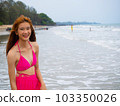 young girl sitting on the beach. by sea. tropical beach. summer style. 103350026