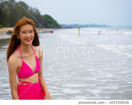 young girl sitting on the beach. by sea. tropical beach. summer style. young girl sitting on the beach. by sea. tropical beach. summer style. 103350026