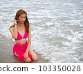 young girl sitting on the beach. by sea. tropical beach. summer style. 103350028