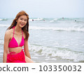 young girl sitting on the beach. by sea. tropical beach. summer style. 103350032