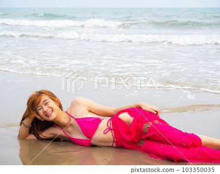 young girl sitting on the beach. by sea. tropical beach. summer style. young girl sitting on the beach. by sea. tropical beach. summer style. 103350035