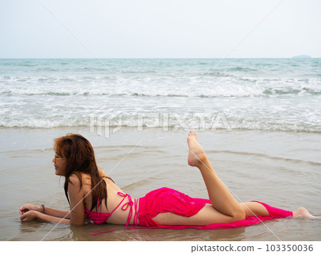 young girl sitting on the beach. by sea. tropical beach. summer style. young girl sitting on the beach. by sea. tropical beach. summer style. 103350036