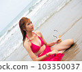 young girl sitting on the beach. by sea. tropical beach. summer style. 103350037