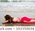 young girl sitting on the beach. by sea. tropical beach. summer style. 103350038