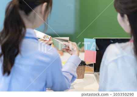 Rear view of a young female designer choosing a color scheme 103350290
