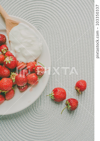 Bunch of bananas and strawberries. Photo toned style Instagram filters. Concept of healthy breakfast. Flatlay Bunch of bananas and strawberries. Photo toned style Instagram filters. Concept of healthy breakfast. Flatlay 103350337