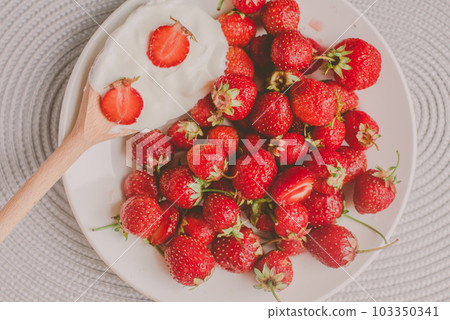 Bunch of bananas and strawberries. Photo toned style Instagram filters. Concept of healthy breakfast. Flatlay Bunch of bananas and strawberries. Photo toned style Instagram filters. Concept of healthy breakfast. Flatlay 103350341