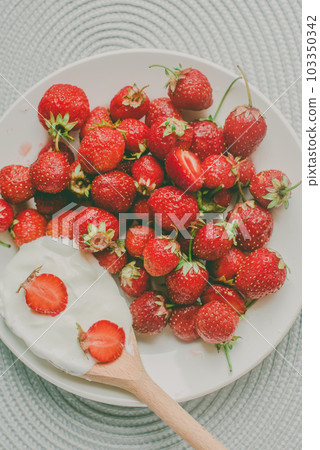 Bunch of bananas and strawberries. Photo toned style Instagram filters. Concept of healthy breakfast. Flatlay Bunch of bananas and strawberries. Photo toned style Instagram filters. Concept of healthy breakfast. Flatlay 103350342