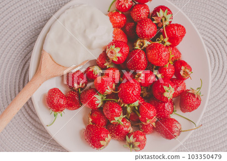 Bunch of bananas and strawberries. Photo toned style Instagram filters. Concept of healthy breakfast. Flatlay Bunch of bananas and strawberries. Photo toned style Instagram filters. Concept of healthy breakfast. Flatlay 103350479
