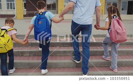 father with many children takes children school with backpacks. group children climb school stairs with briefcase their back. group children go hand hand school. friendly happy family team. student . 103350951